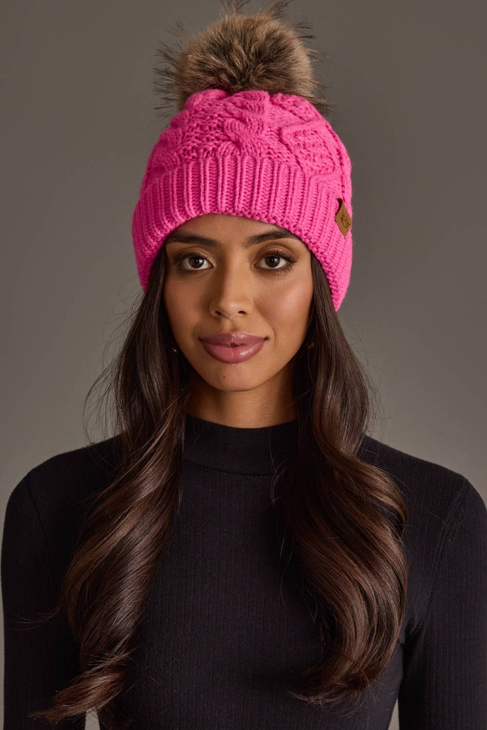 Panache Apparel Co. bright pink cable knit pom hat with faux fur pom