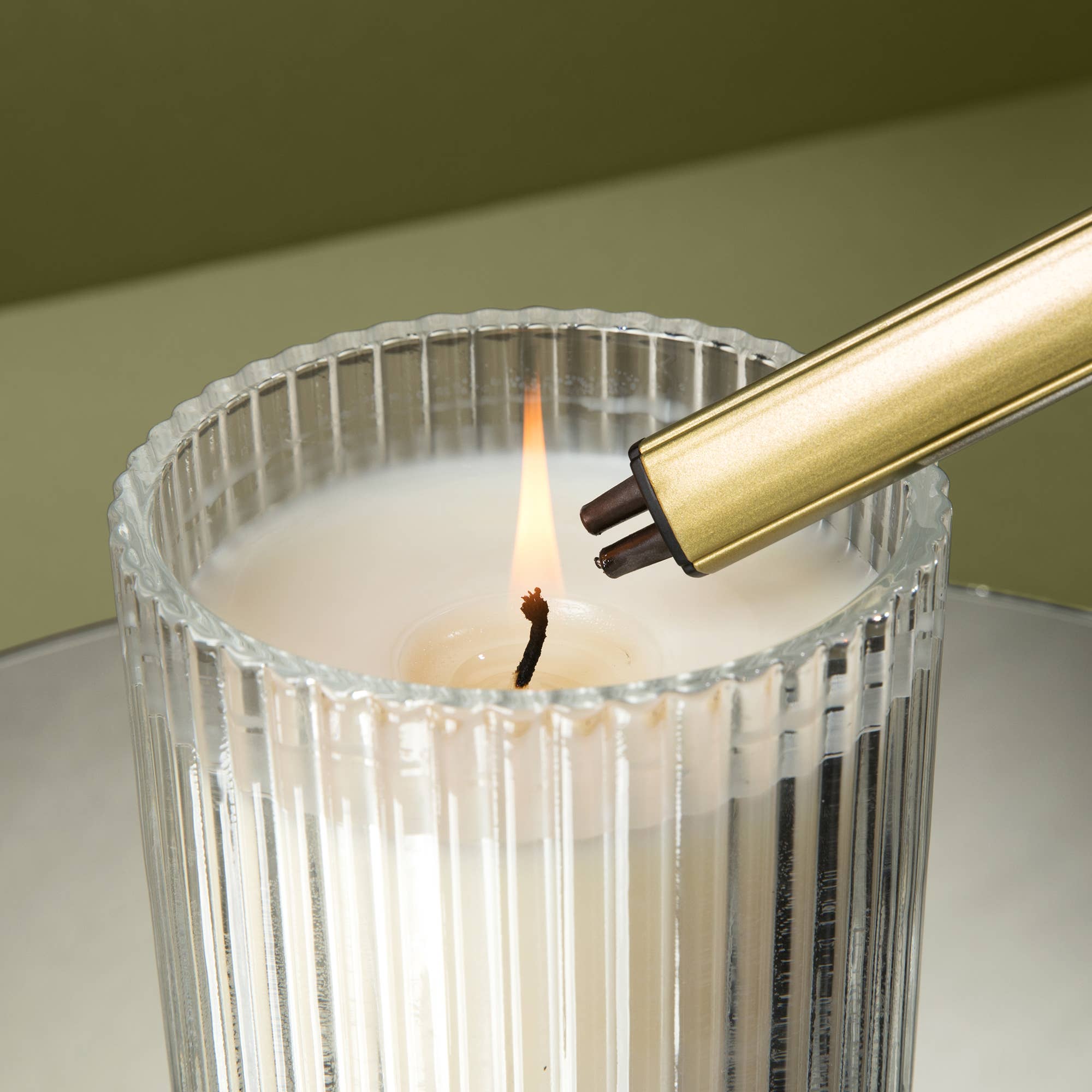 Sweet Water Decor gold electric lighter, styled with candle
