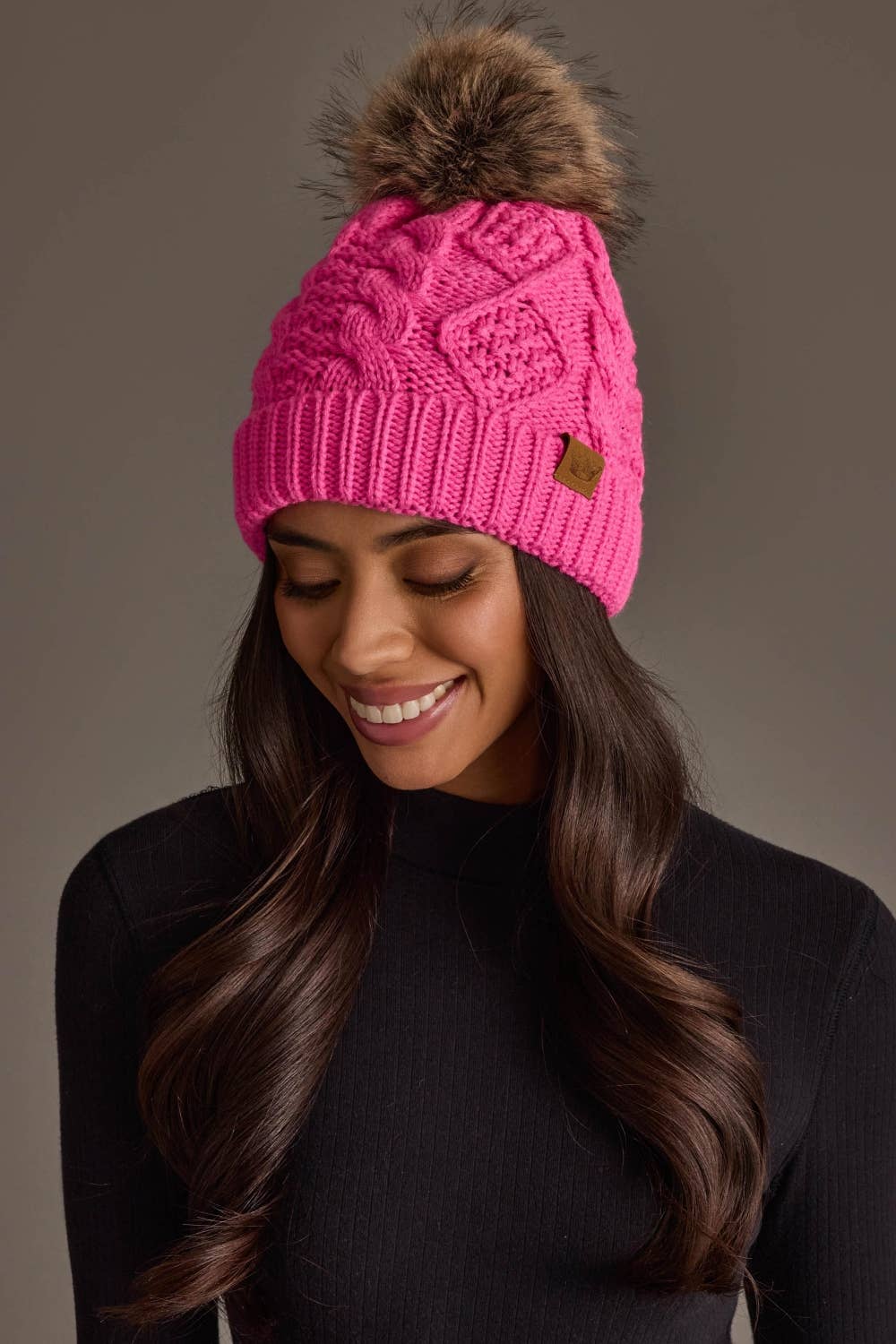 Panache Apparel Co. bright pink cable knit pom hat with faux fur pom