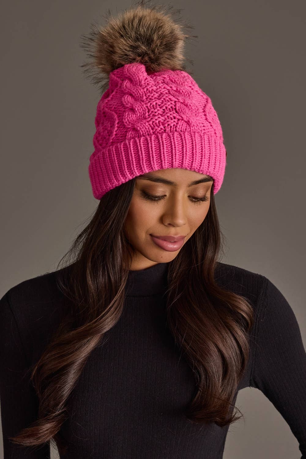 Panache Apparel Co. bright pink cable knit pom hat with faux fur pom