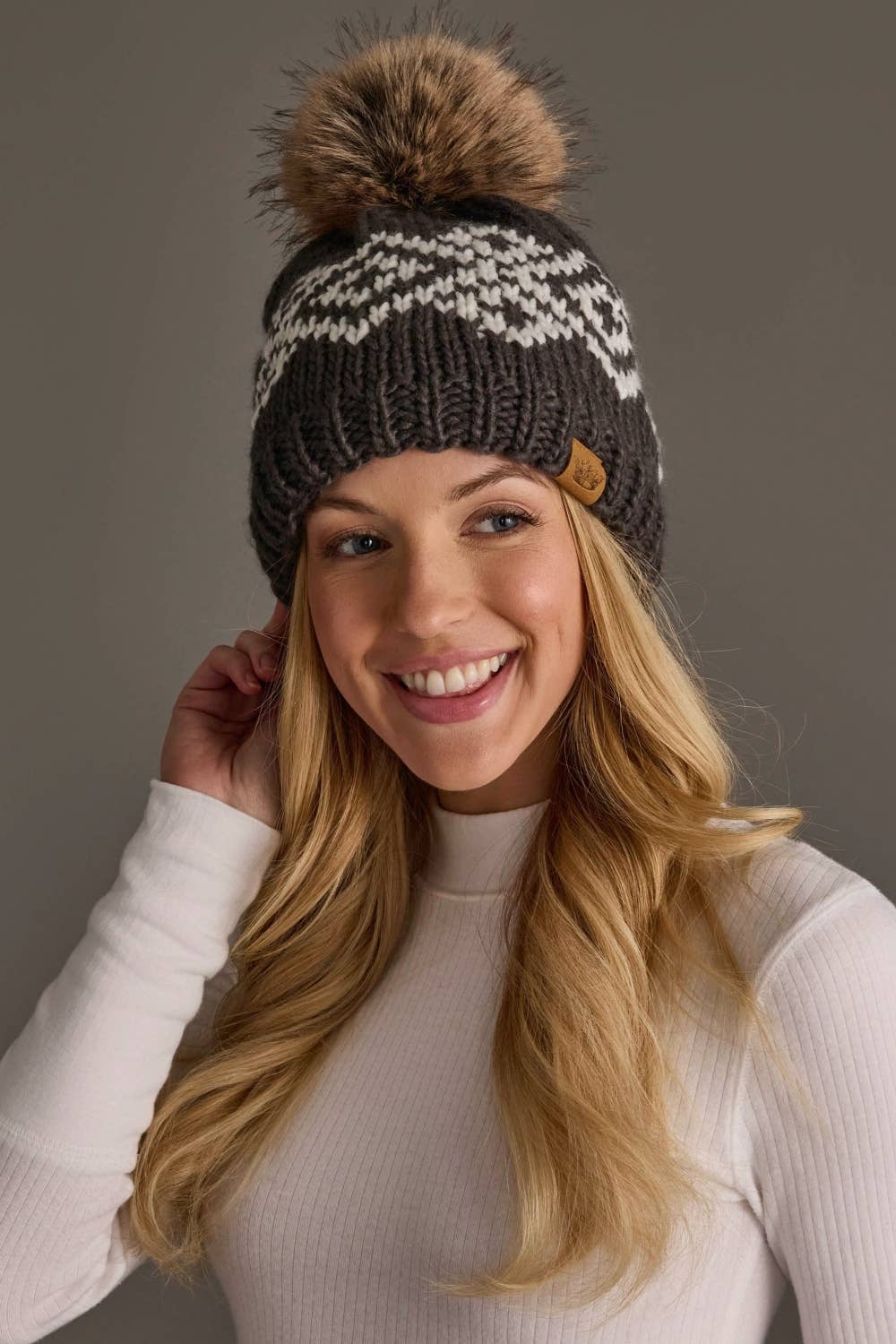 Panache Apparel Co. dark gray and white geometric knit pom hat with faux fur pom