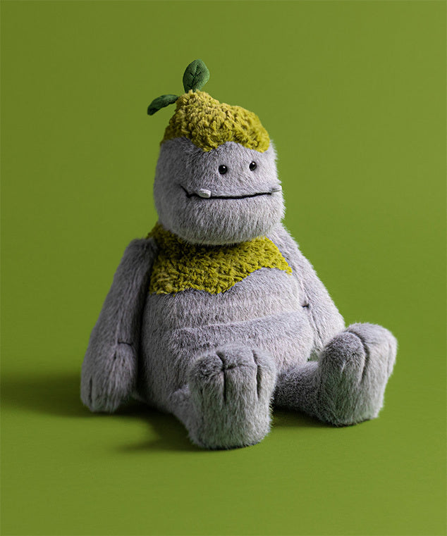 Plush toy with a green hat and scarf on a green background