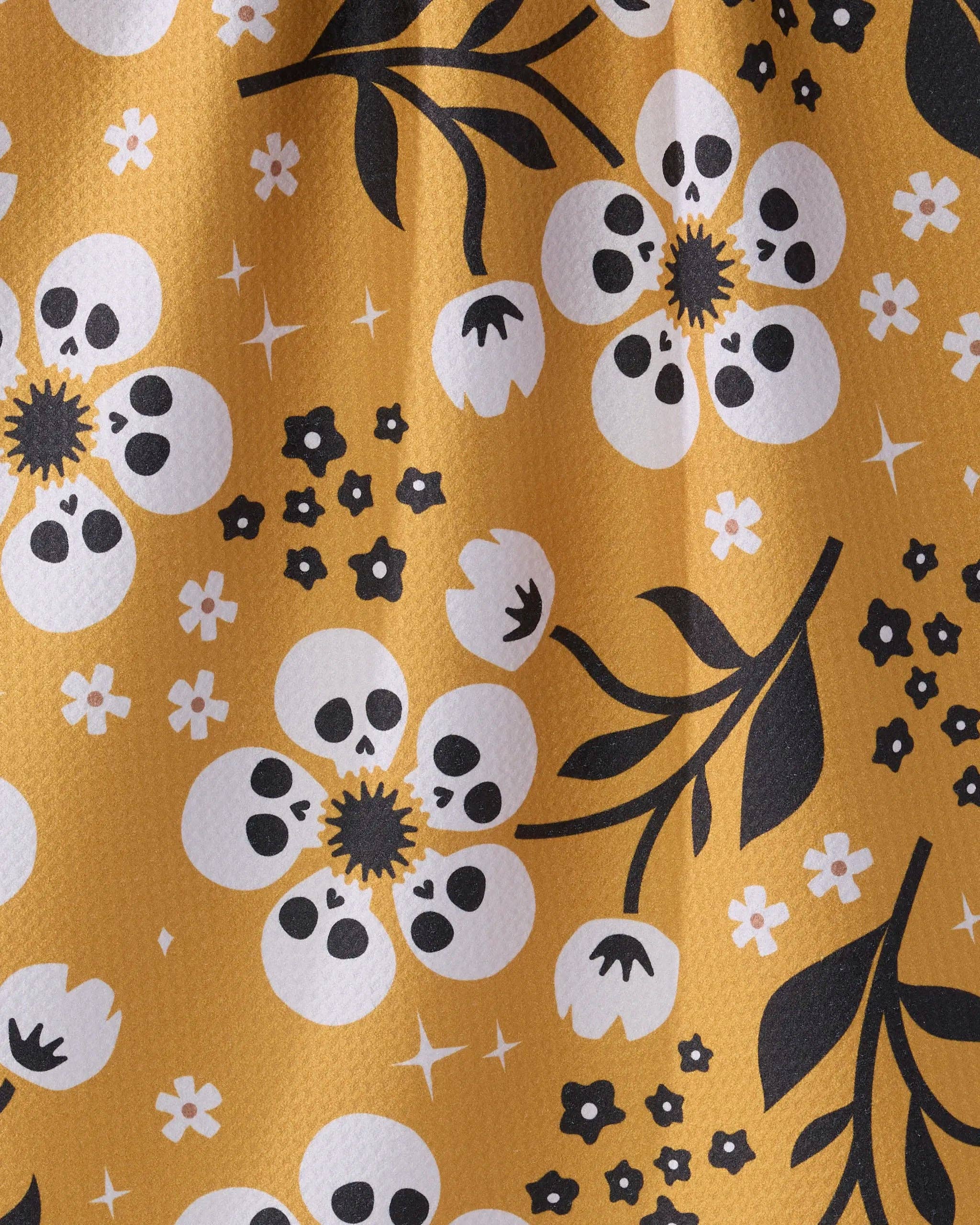 Pattern of skulls and flowers on a yellow background