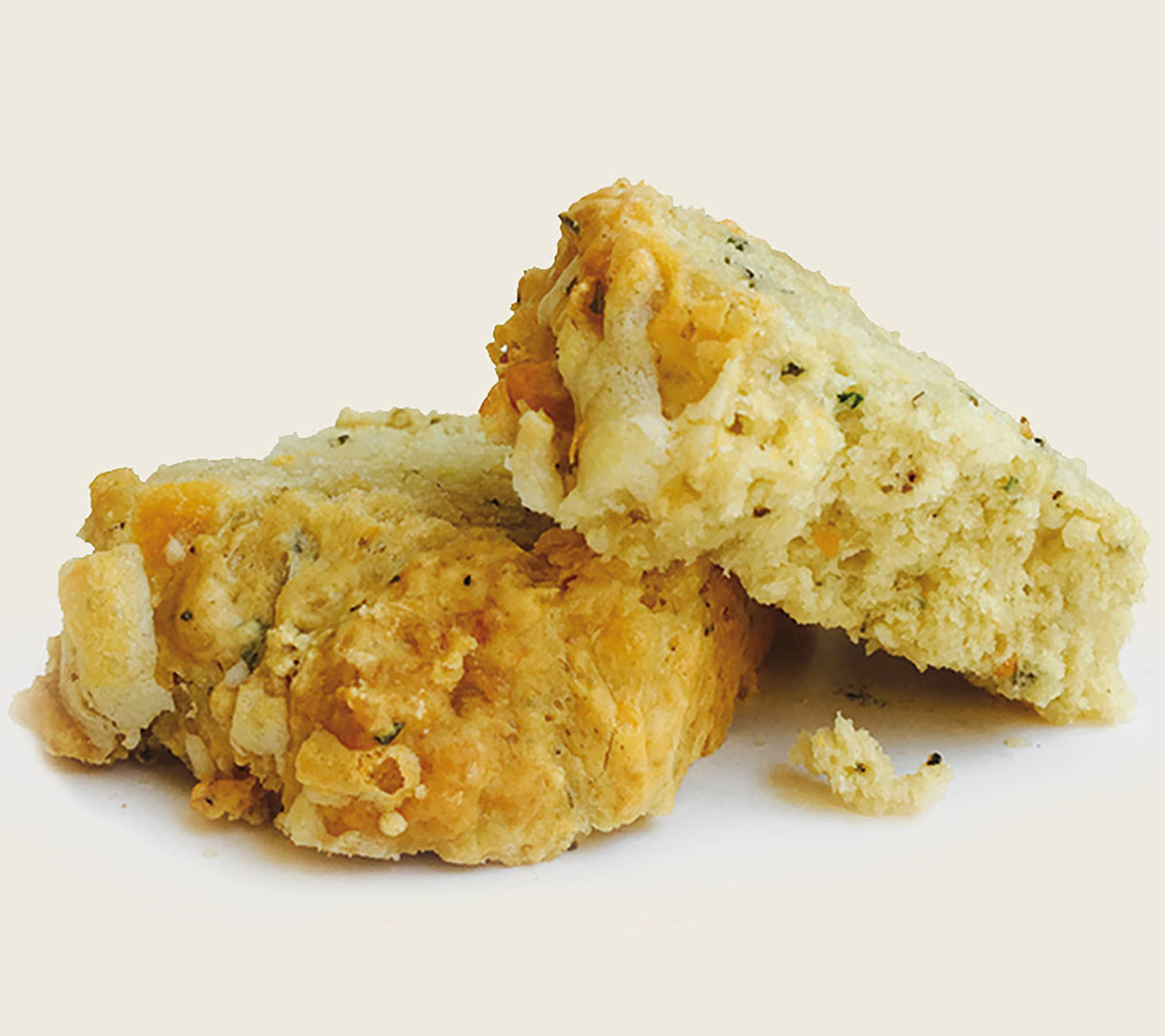 Two pieces of biscuit on a white background