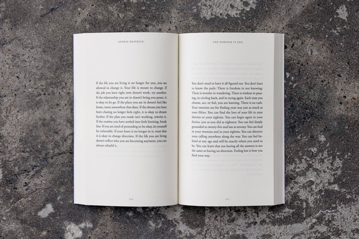 Open book on a textured gray surface