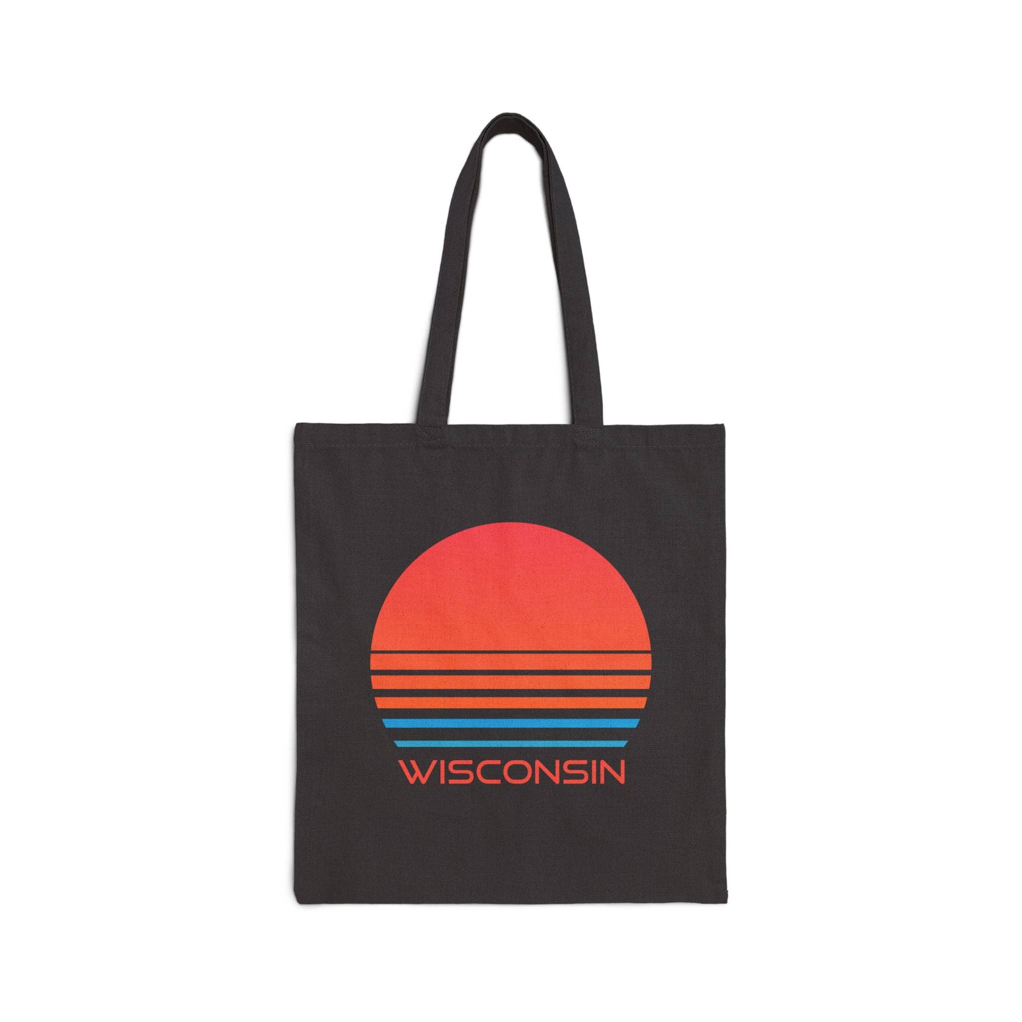 A black canvas tote bag with two handles, featuring a retro sunset graphic in red, orange, and blue stripes above the word 'WISCONSIN' in orange, shown on a plain white background.