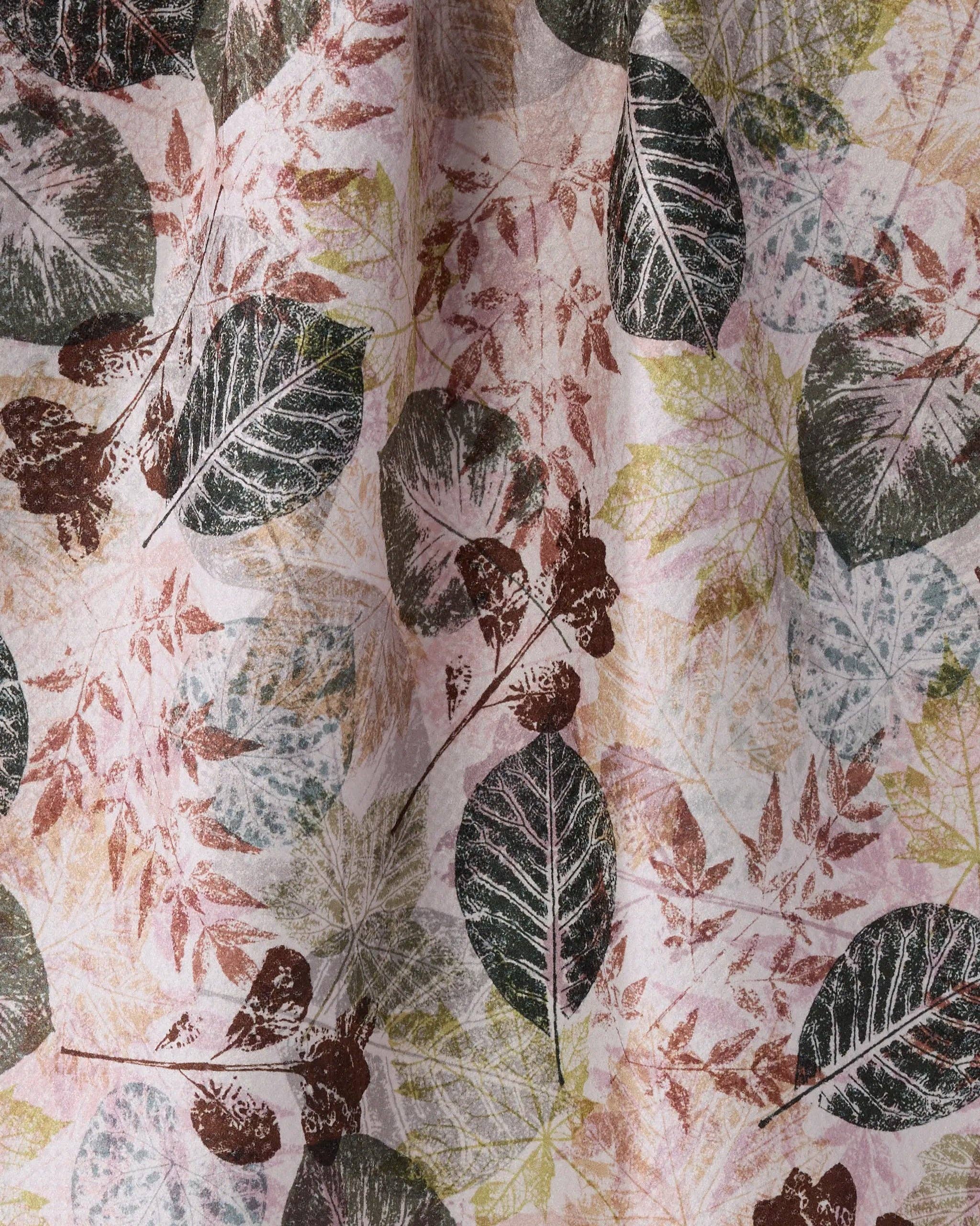 A close-up of a fabric or wallpaper pattern featuring a botanical design with dark green, brown, and muted pink leaves on a light cream background.