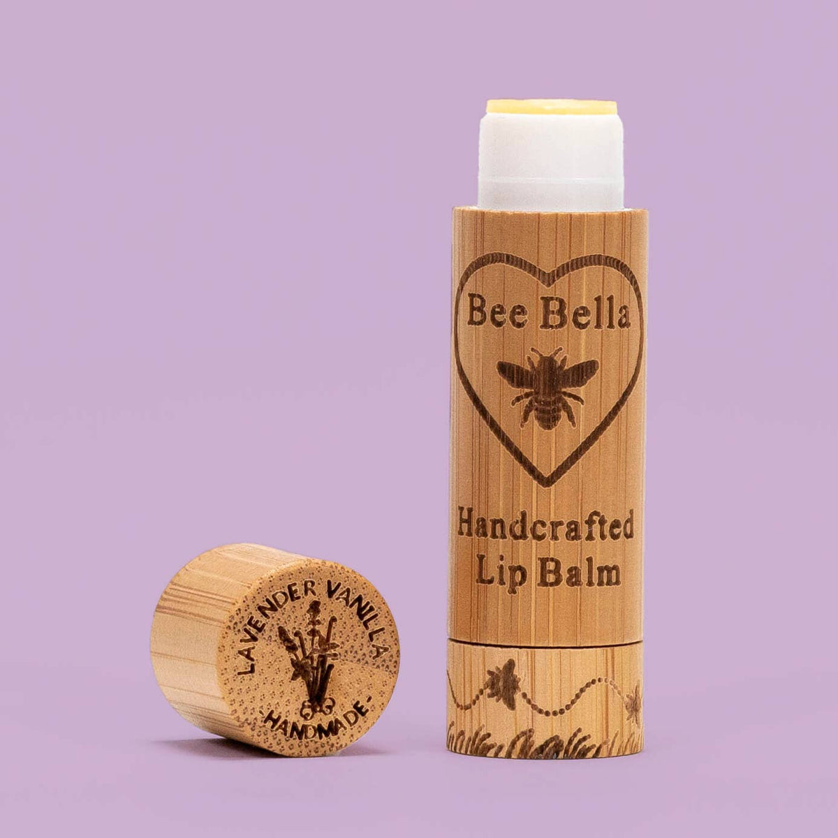 Bee Bella lip balm with wooden container on a purple background