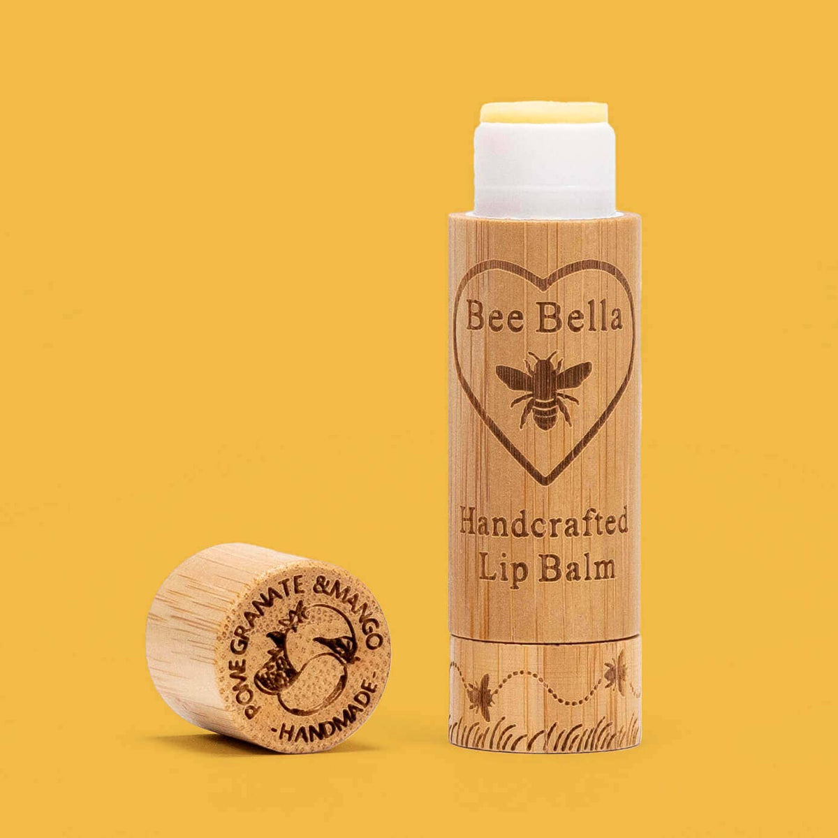 Bee Bella lip balm with wooden container on a yellow background